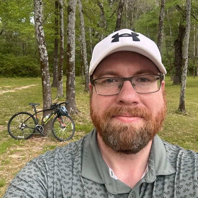Shannon Duncan outdoors with his bicycle